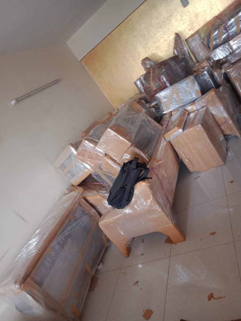 Movers arranging goods inside moving truck