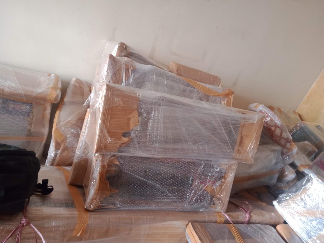 Professional movers packing wooden furniture